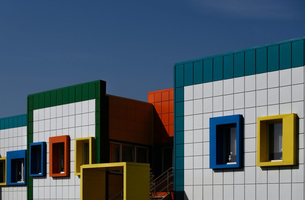 a row of multicolored buildings with a blue sky in the background